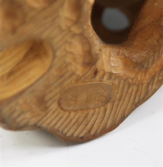 A Japanese boxwood okimono modelled as a dragon and a tiger, early 20th century, height 11cm, associated wood stand